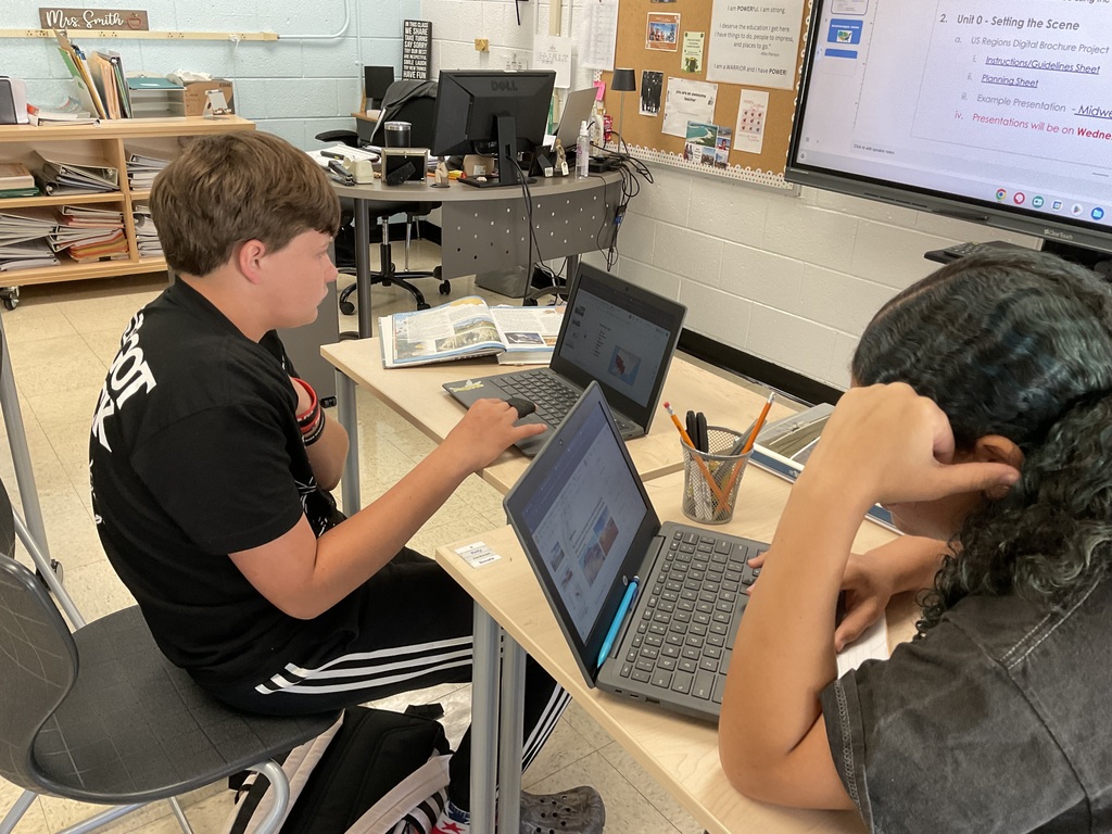 Students working on their digital US regional travel brochure