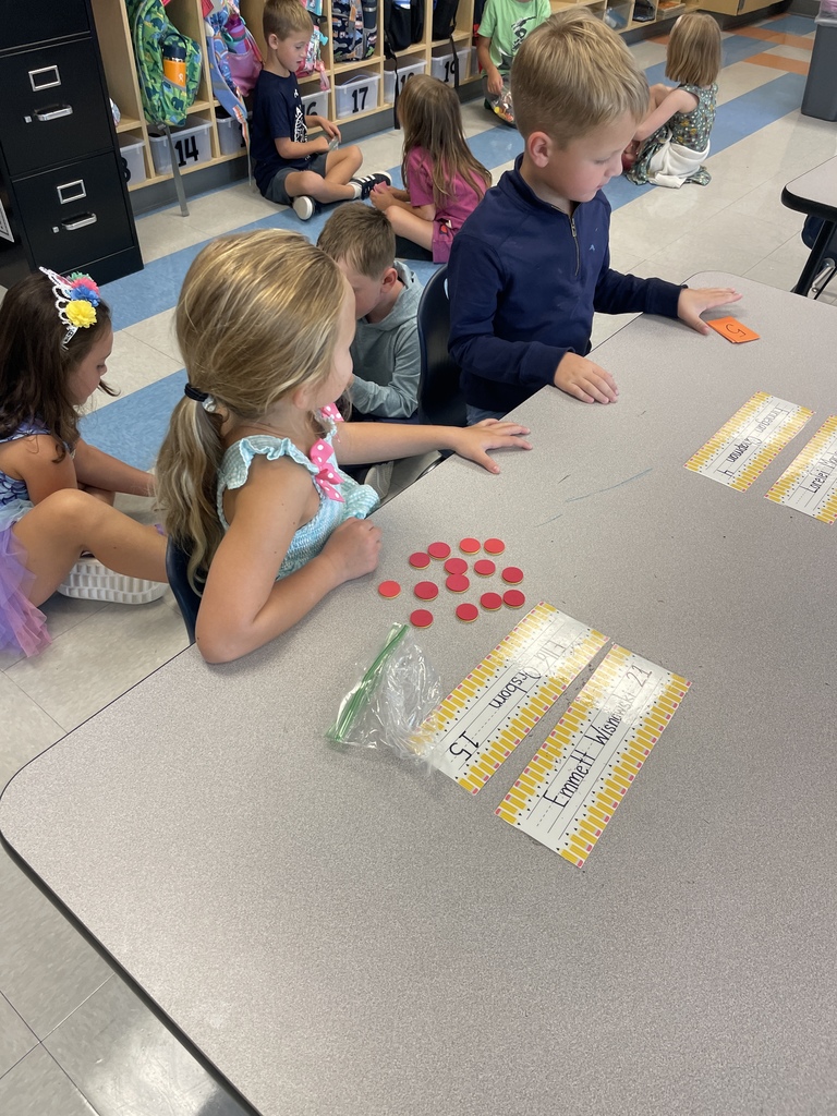 Kindergarten students working in groups while the practice counting