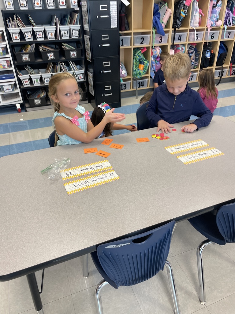 Kindergarten students working in groups while the practice counting