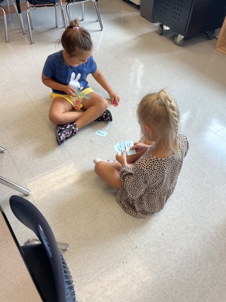 Kindergarten students working in groups while the practice counting