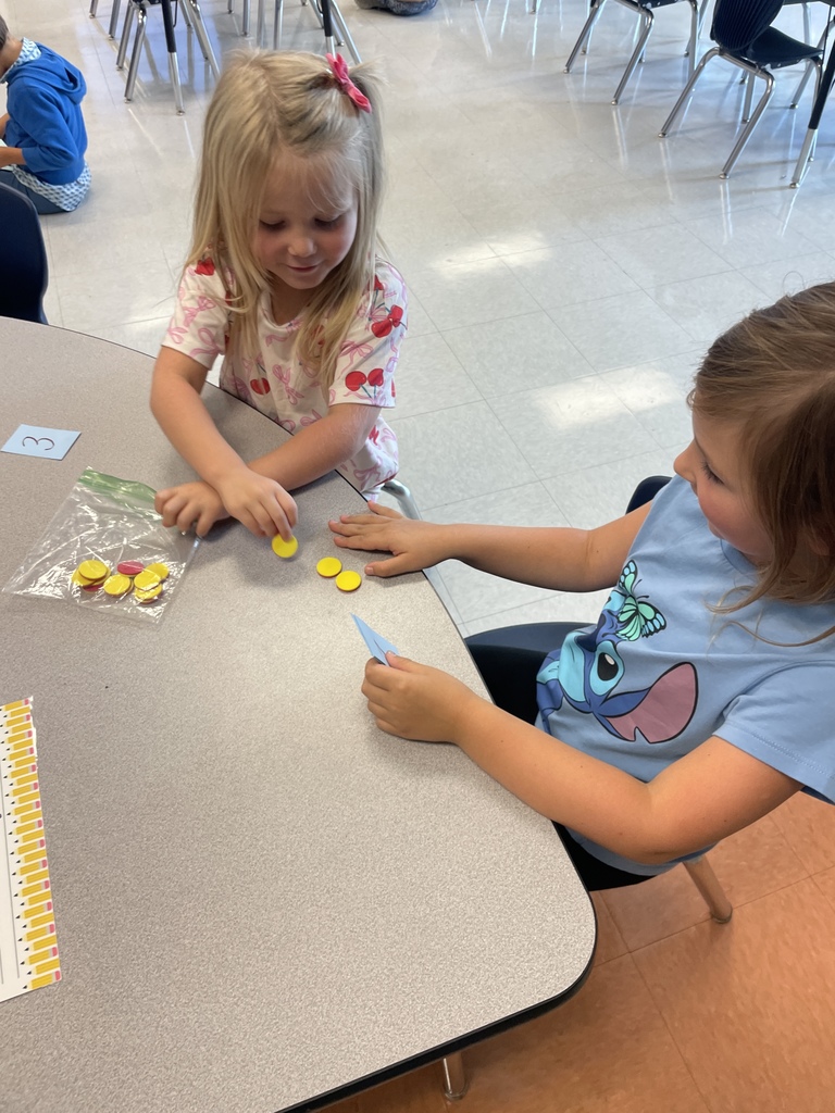 Kindergarten students working in groups while the practice counting