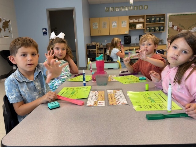 first graders working on spelling at their tables