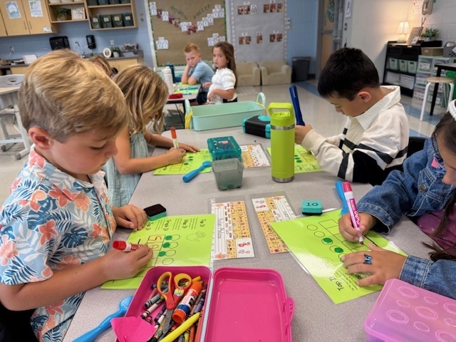 first graders working on spelling at their tables