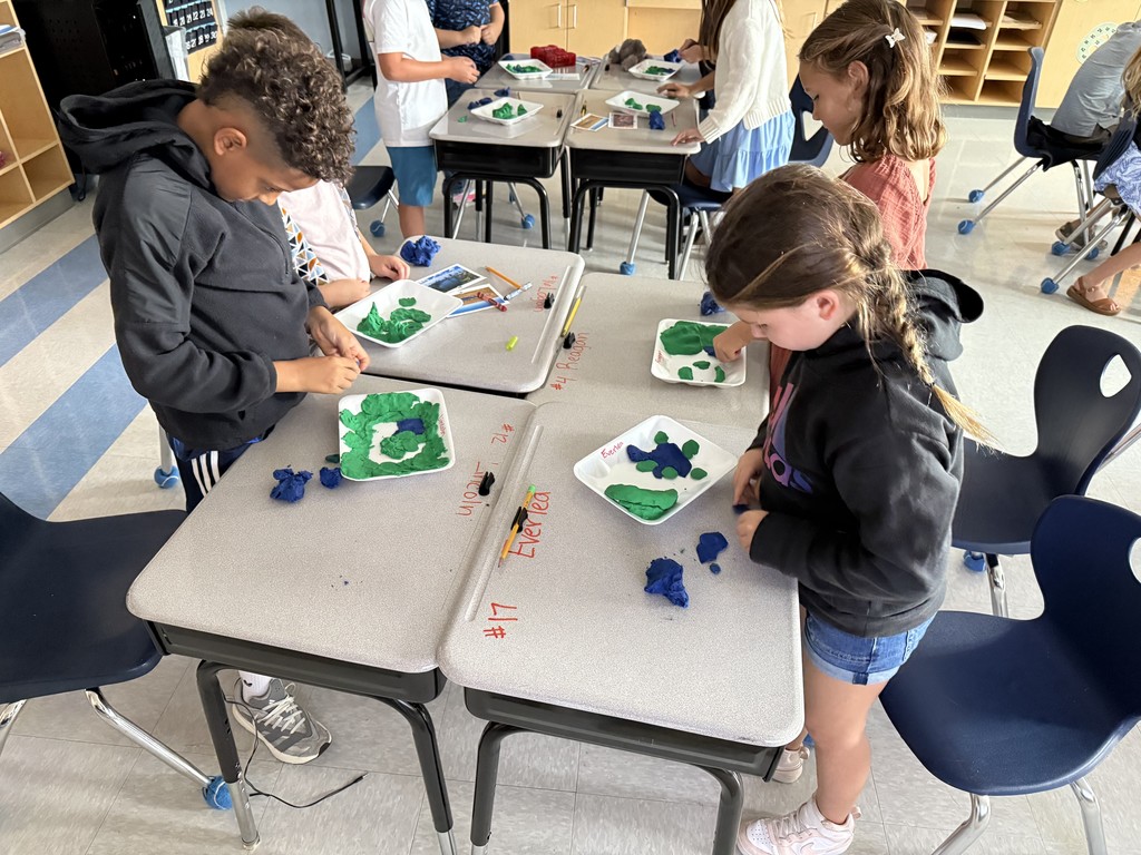 3rd graders using dough to create landforms and water
