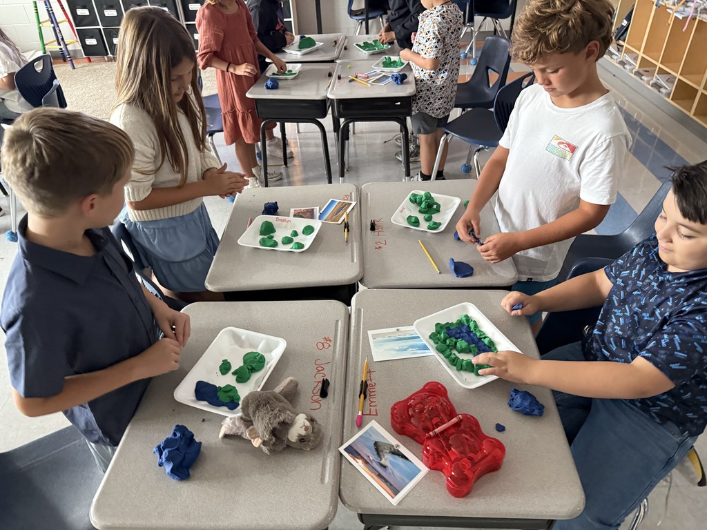 3rd graders using dough to create landforms and water