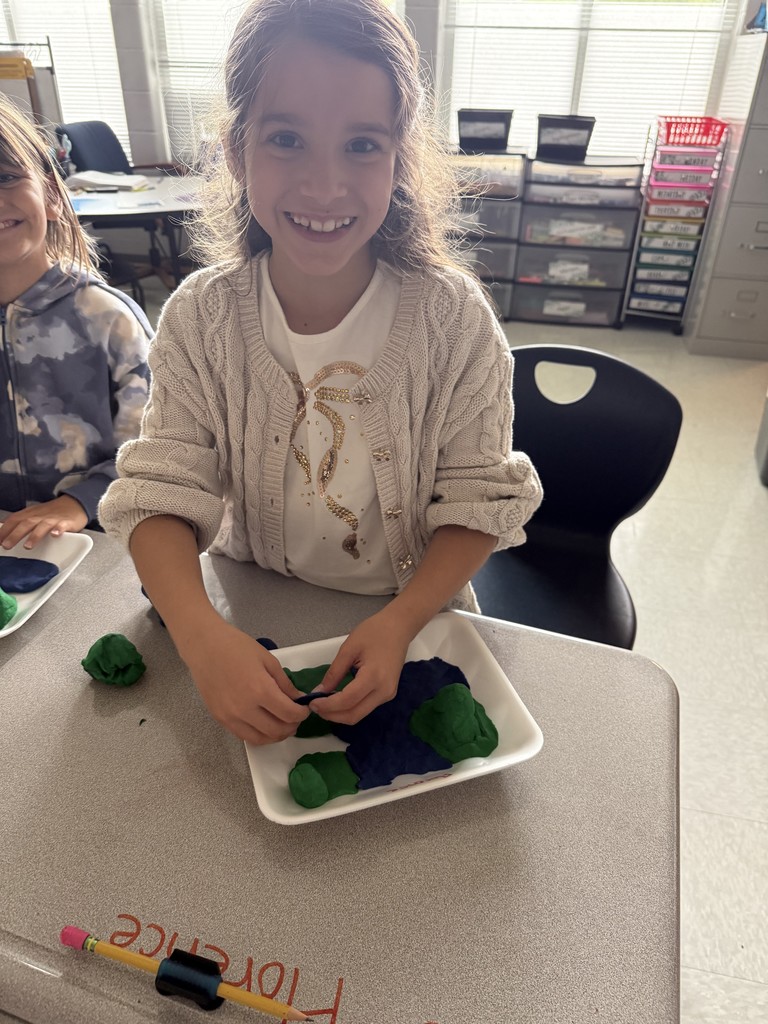 3rd graders using dough to create landforms and water