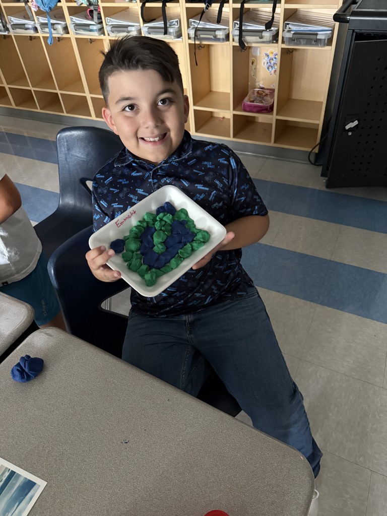 3rd graders using dough to create landforms and water