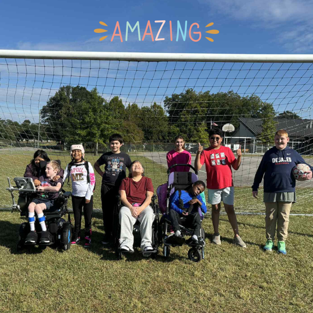 students posing in a group on soccer field