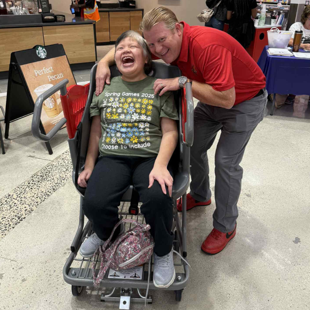 administrator and student posing in store