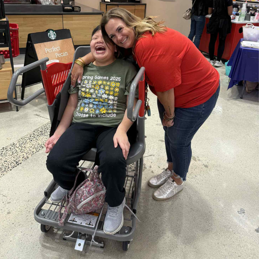 teacher and student posing in store