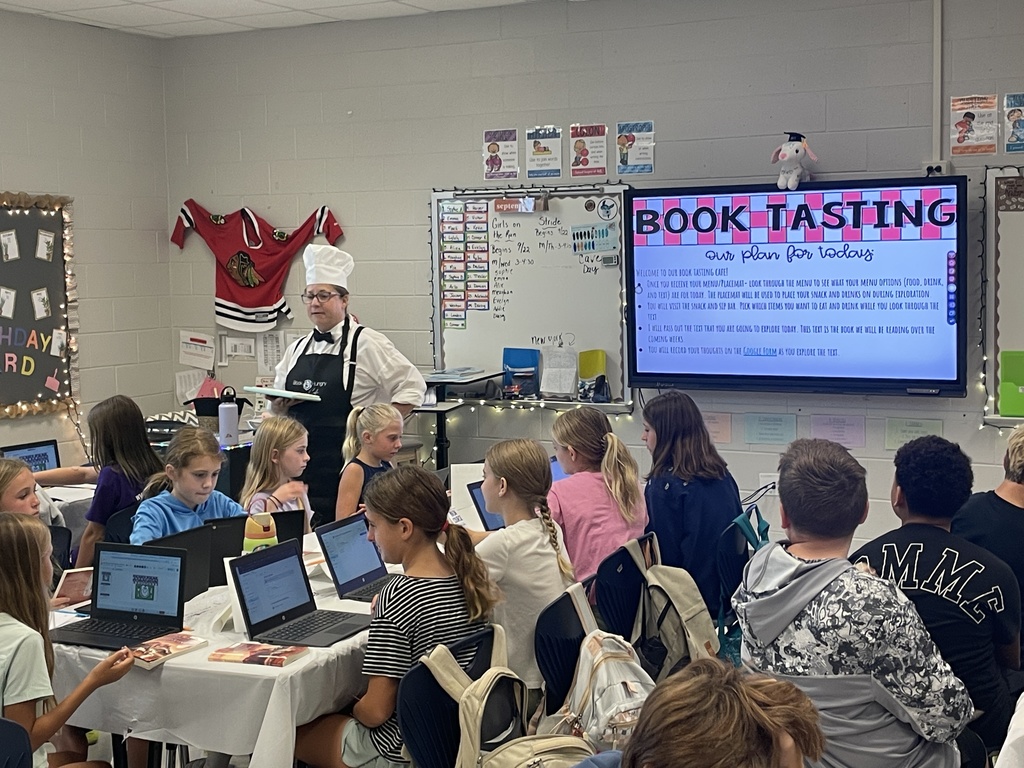 5th grade teacher standing in front of the room teaching