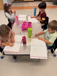 first graders working on math at their tables