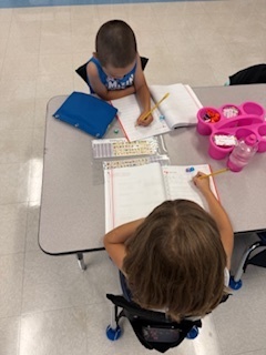 first graders working on math at their tables