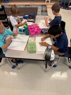 first graders working on math at their tables