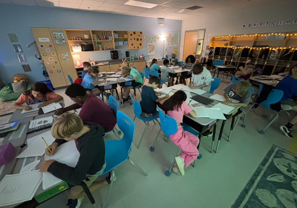 4th graders working in groups during a reading lesson