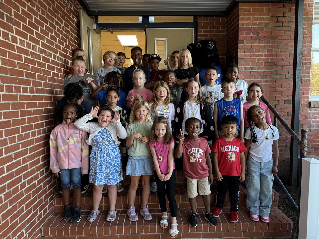 Students of the week standing on school steps making silly faces