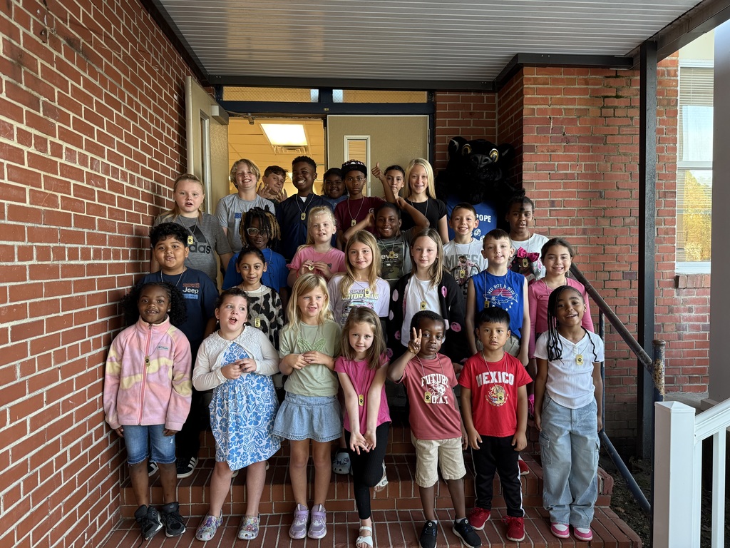 Students of the week standing on school steps