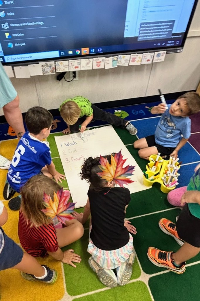 preK students making fruit salad