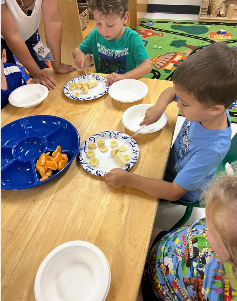 preK students making fruit salad