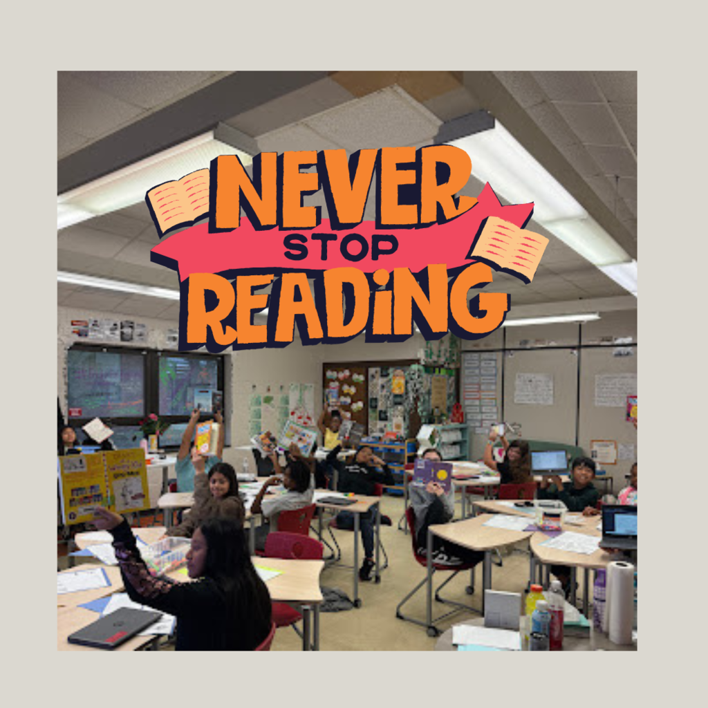 students holding up books they are reading in the classroom