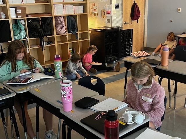 students independently reading in their classrooms