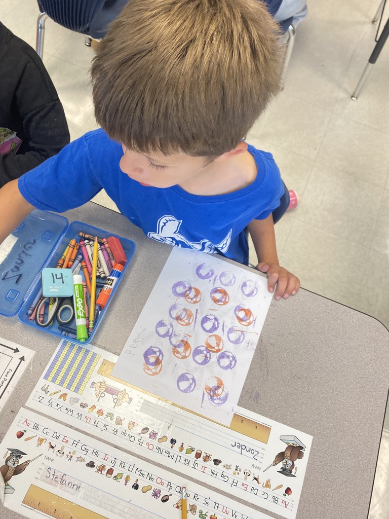 1st grade student stamping out illustrations
