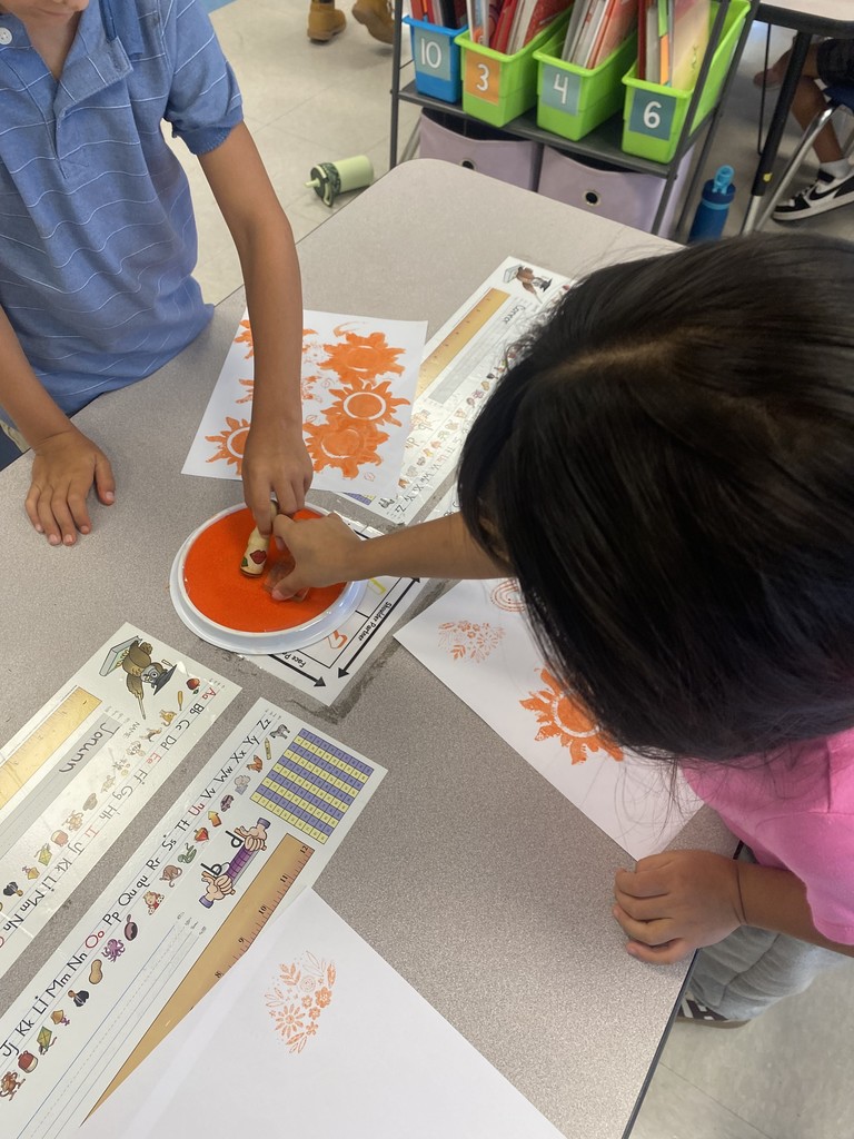 1st grade student stamping out illustrations