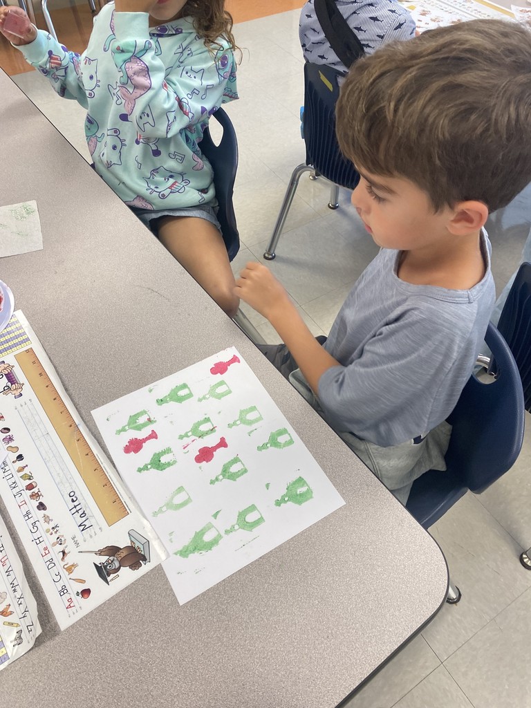 1st grade student stamping out illustrations