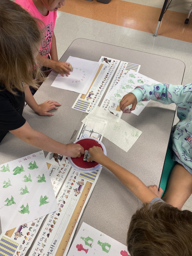 1st grade student stamping out illustrations