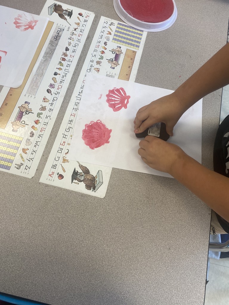 1st grade student stamping out illustrations