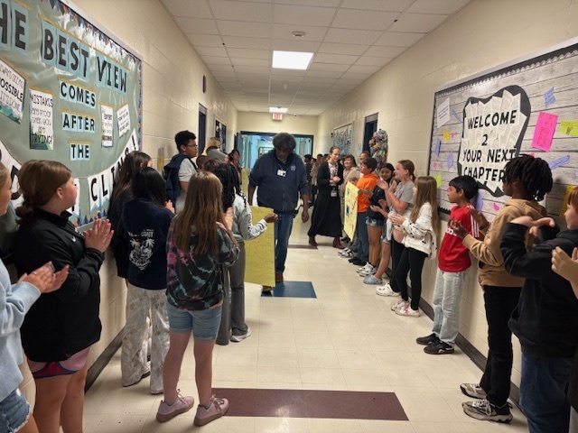 Mr. Newkirk walking down the hallway getting an applause for National Custodian Day.