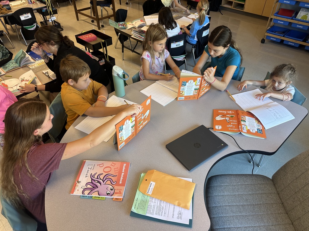 middle school students reading with elementary students 
