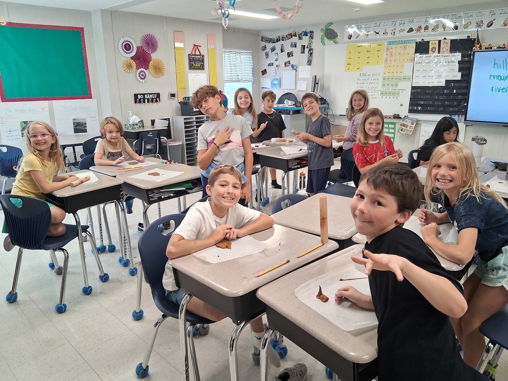 3rd graders using clay at their desks 