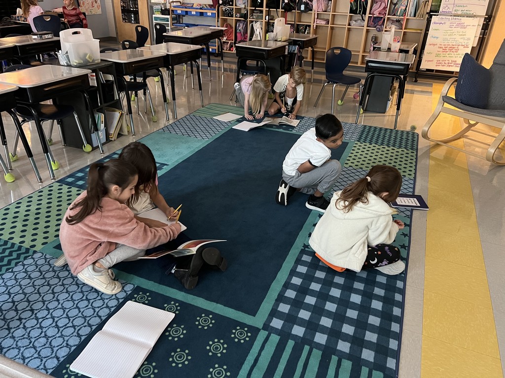 2nd graders sitting on the floor reading together