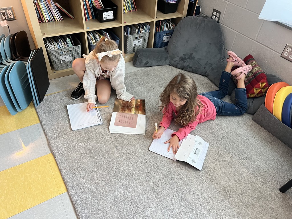 2nd graders sitting on the floor reading together