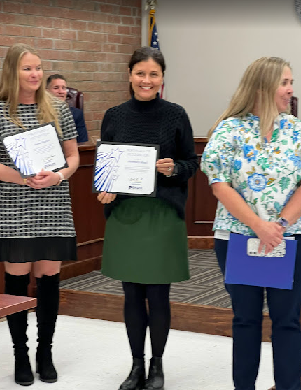 Teacher being recognized at the BOE meeting