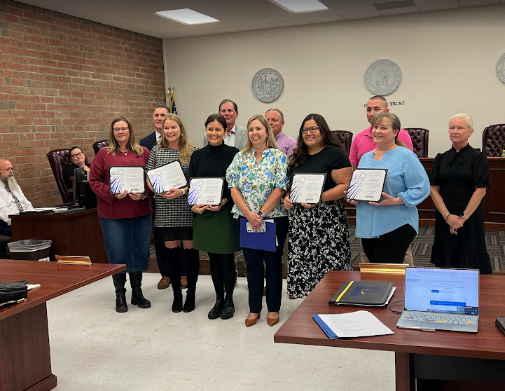 Teacher being recognized at the BOE meeting
