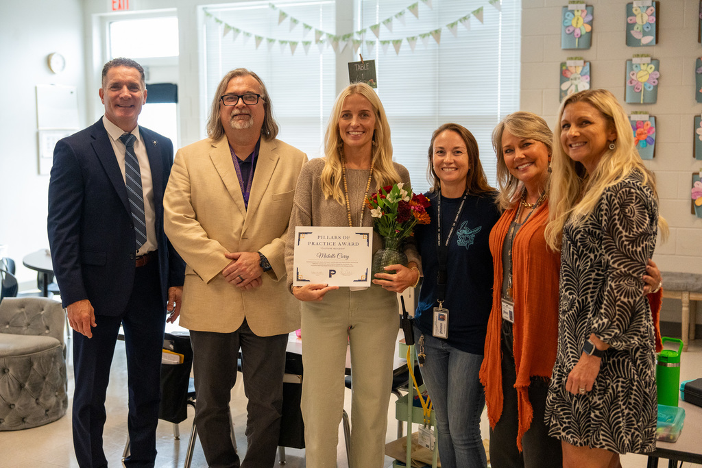 Teacher being recognized by the superintendent