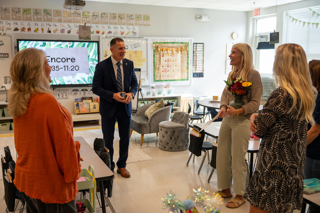 Teacher being recognized by the superintendent