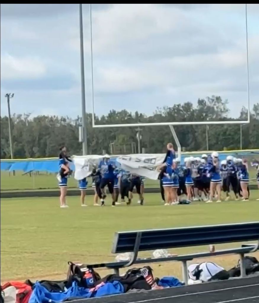 Grizzlies running onto the football field