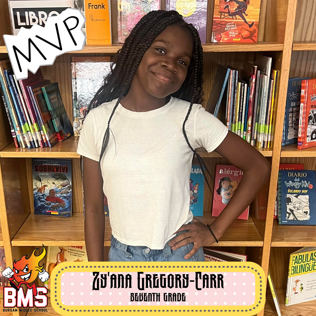 student posing in front of bookshelf with graphics and name