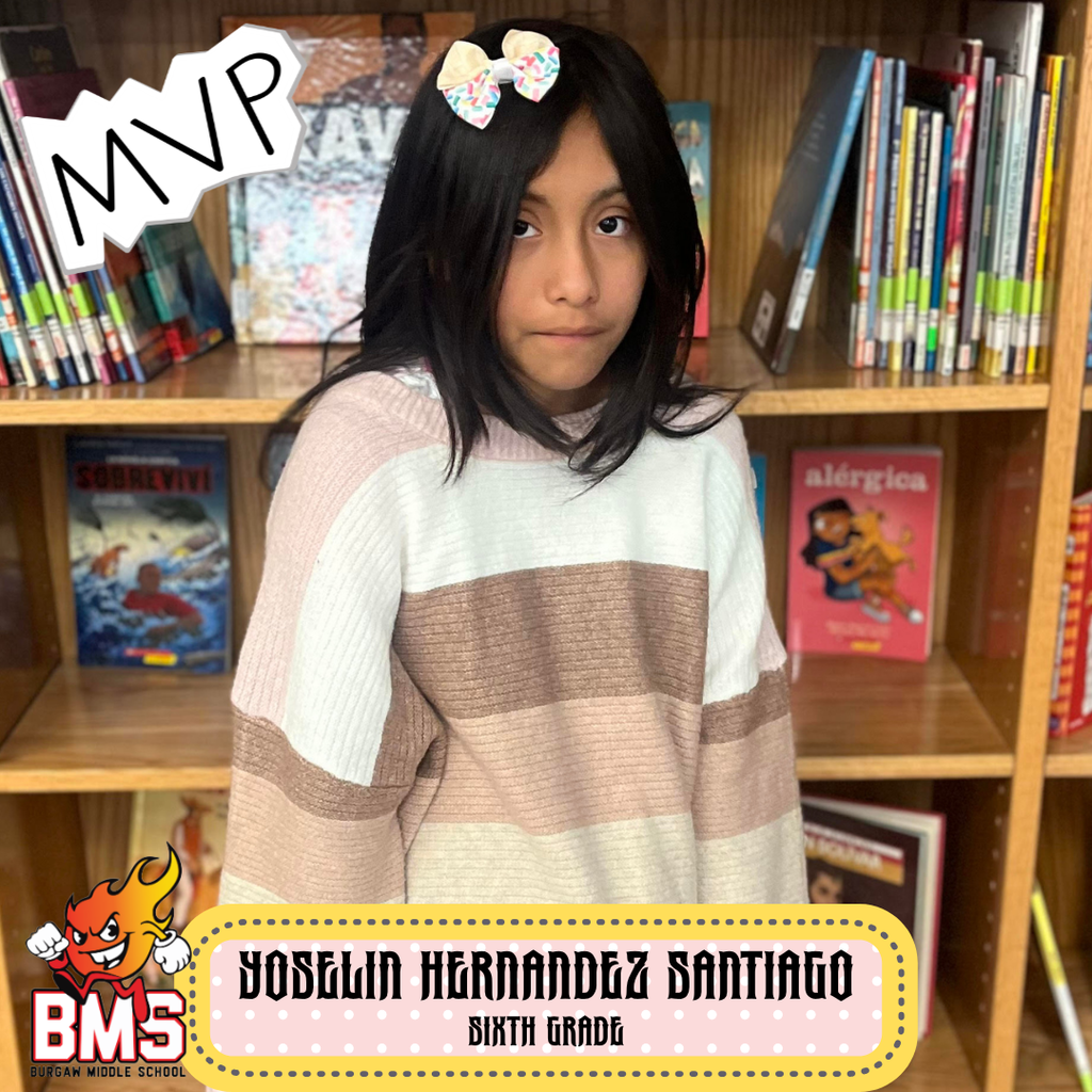 student posing in front of bookshelf with graphics and name