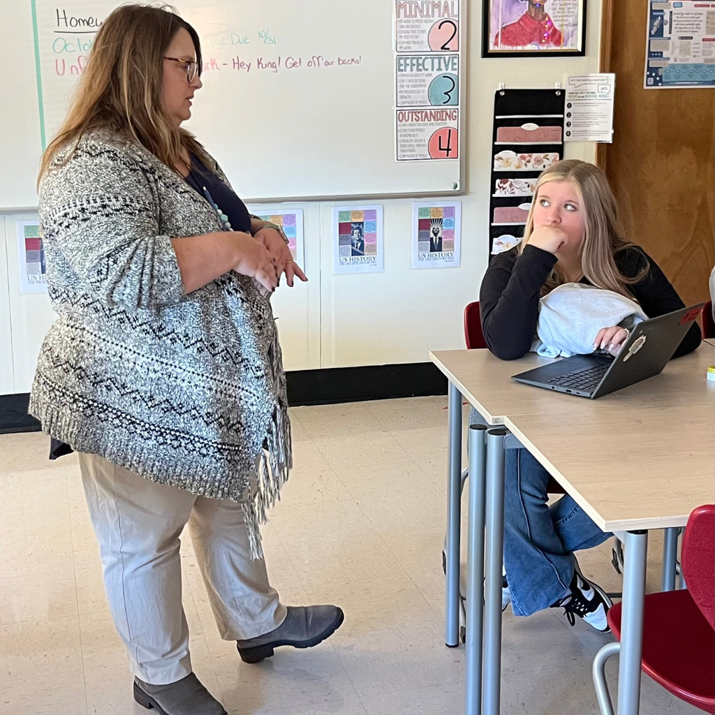 teacher talking with student