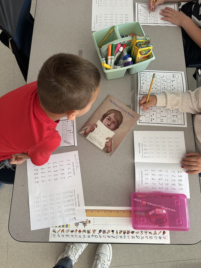 students translating names & words into braille