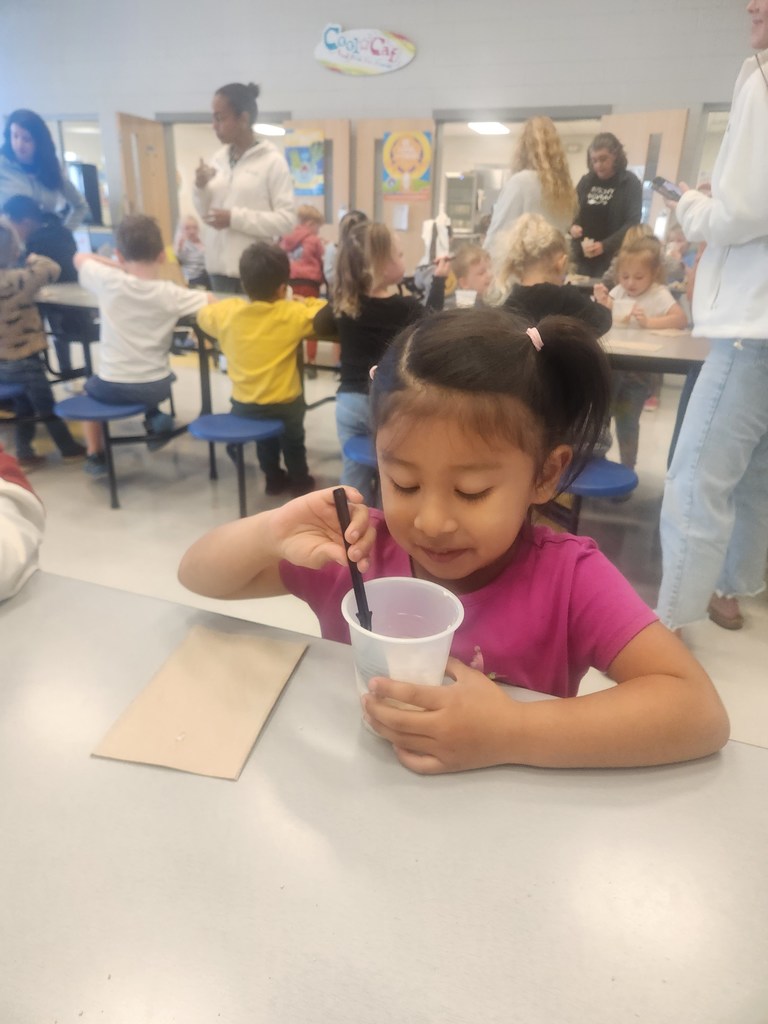 prek student eating apple pie in a cup