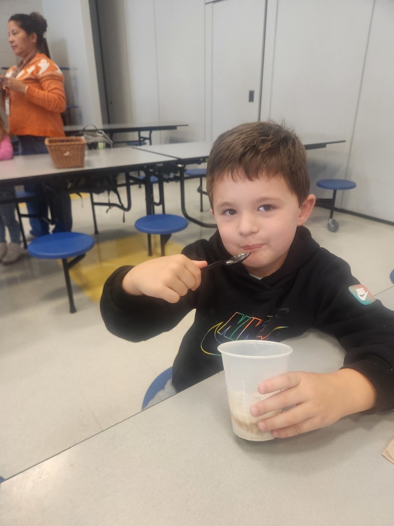 prek student eating apple pie in a cup