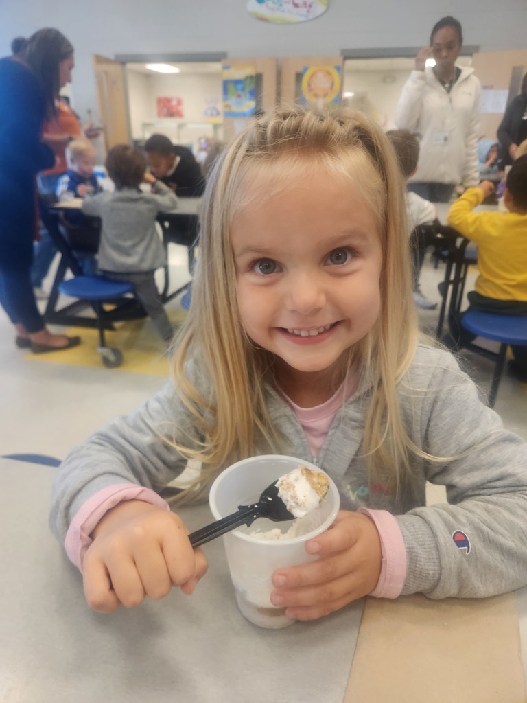prek student eating apple pie in a cup