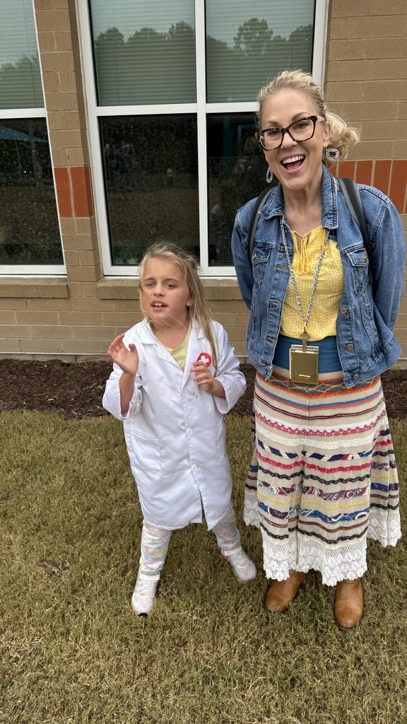 student and IA standing outside together