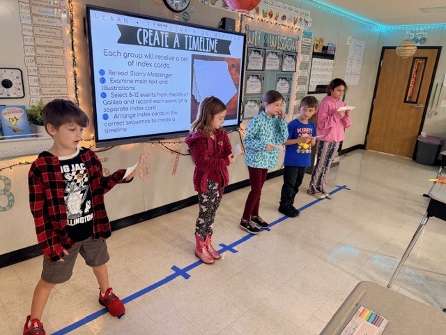 third graders acting out a human timeline of events