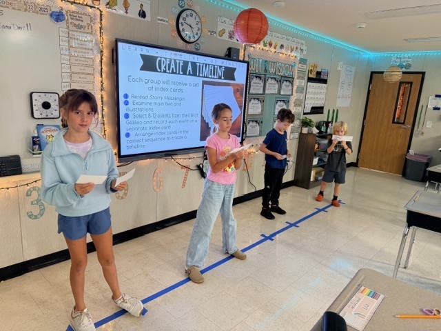 third graders acting out a human timeline of events